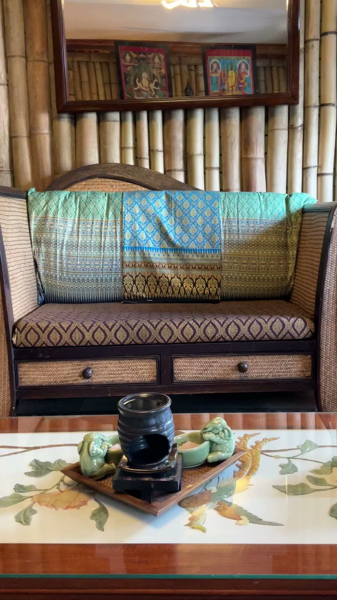 Silk-covered lounge in front of a bamboo wall