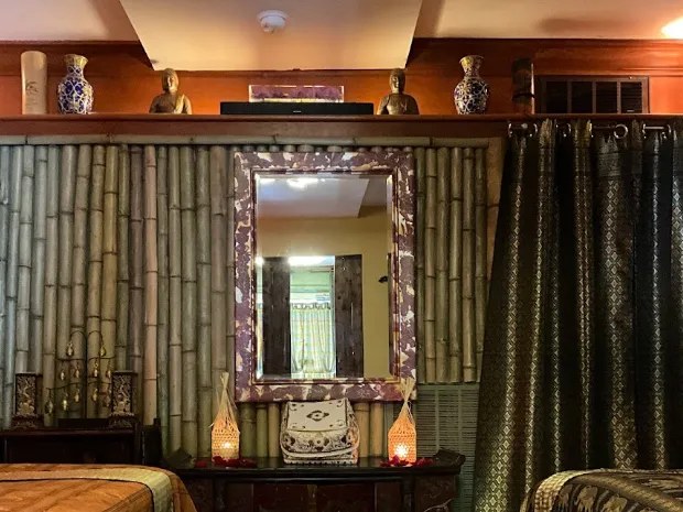 Bamboo wall with a mirror and glowing lamps